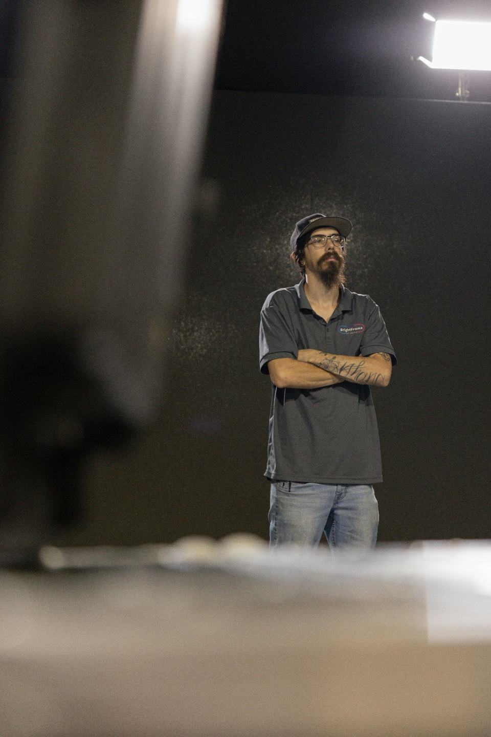 Arlen, Bright Frame Studios Head of Quality Control, standing in the QC bay